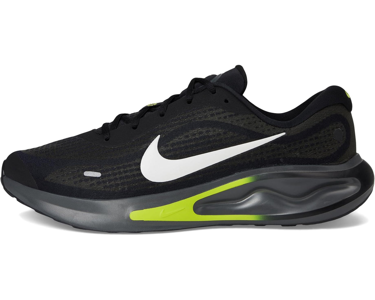 Black running shoe with white swoosh and neon green stripe on the midsole