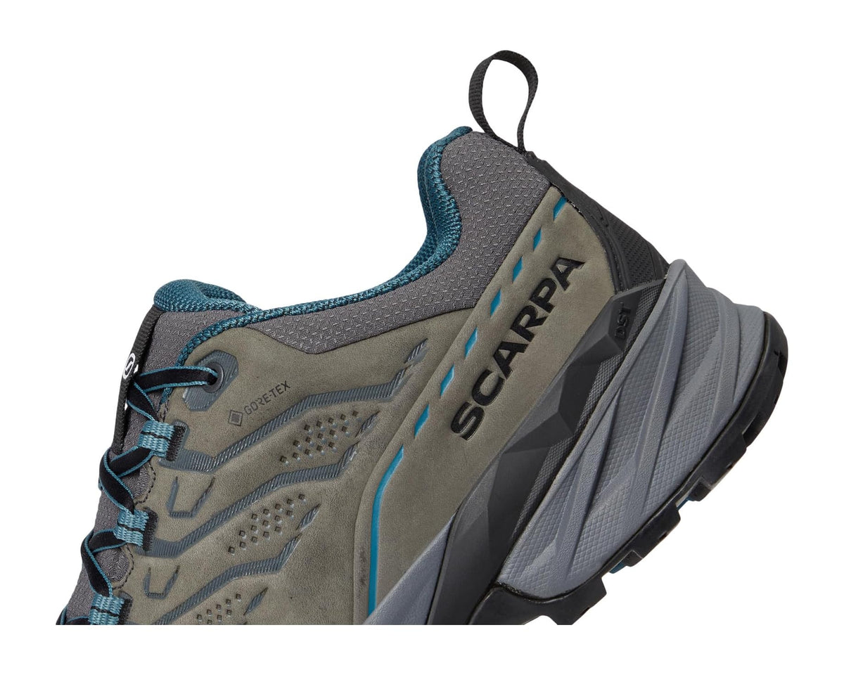 Men's hiking shoe close-up of side logo and teal piping on gray-taupe upper