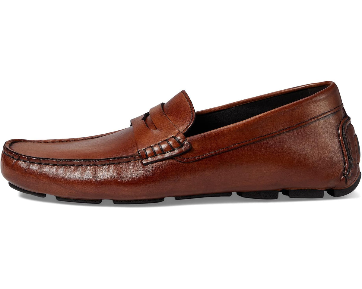 Brown leather penny loafer, angled side view with penny keeper strap detail