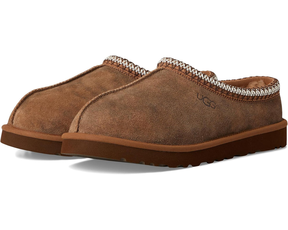 Chestnut suede slip-on slippers with UGG logo, braided trim, and rubber sole