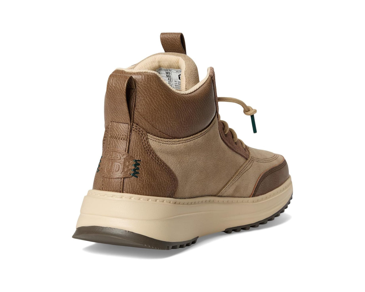 Men's brown and tan boot with padded ankle collar, side logo patch, and lugs