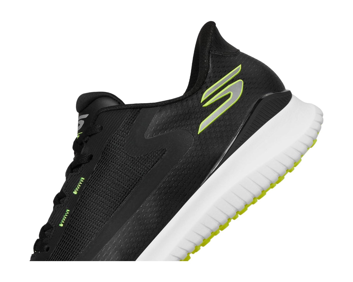 Black slip-on golf shoe upper close-up, mesh texture with neon green S logo
