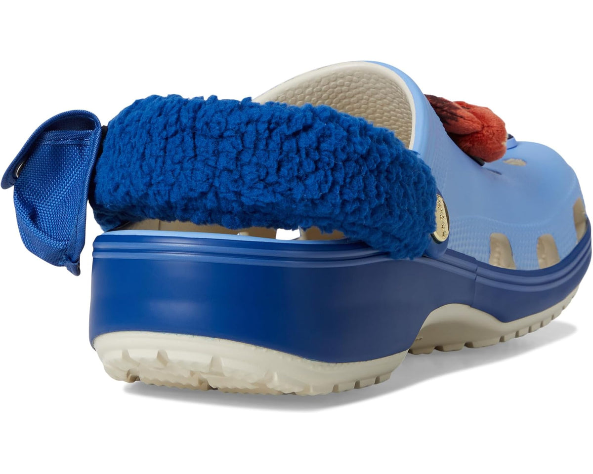 Light blue clog rear view with dark blue plush lining and strap; textured sole