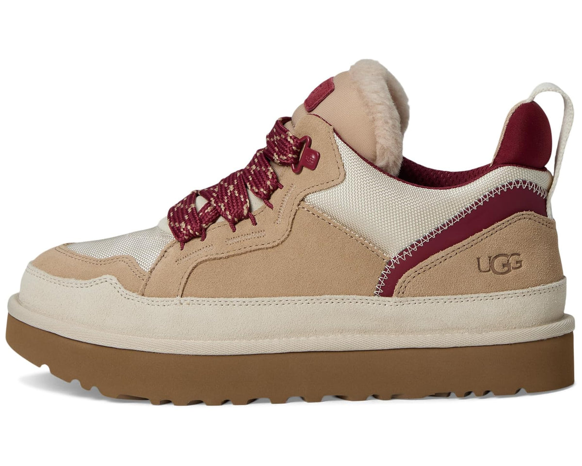 Men's UGG low-top sneakers, front three-quarter view: tan suede, burgundy trim, fur collar.