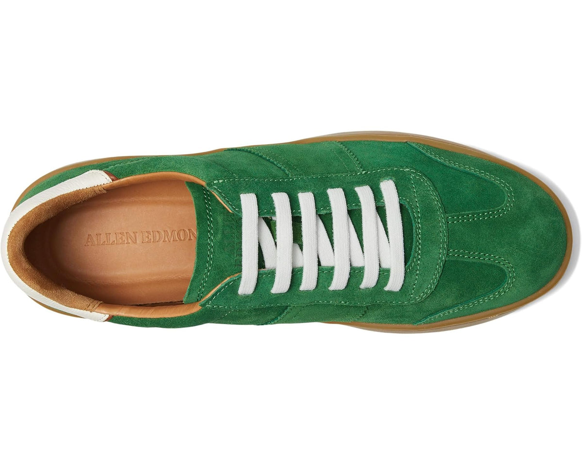 Green suede lace-up sneaker with white laces and tan interior collar.