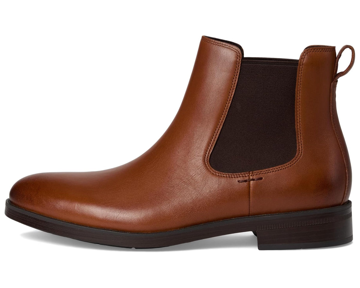 Brown leather Chelsea boots with elastic gore and pull tab at the back collar
