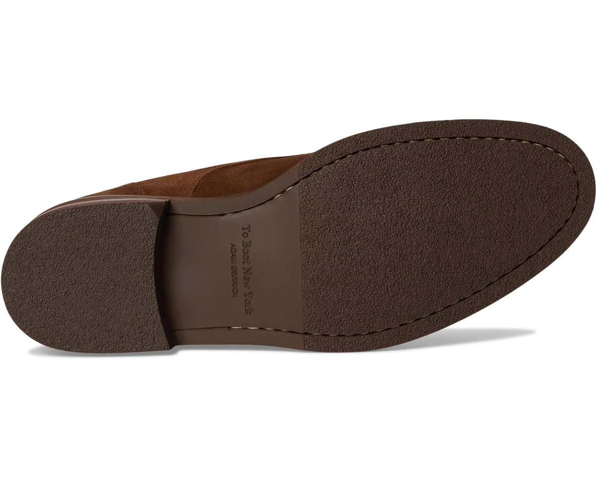Dark brown suede chukka boot outsole view with low stacked heel