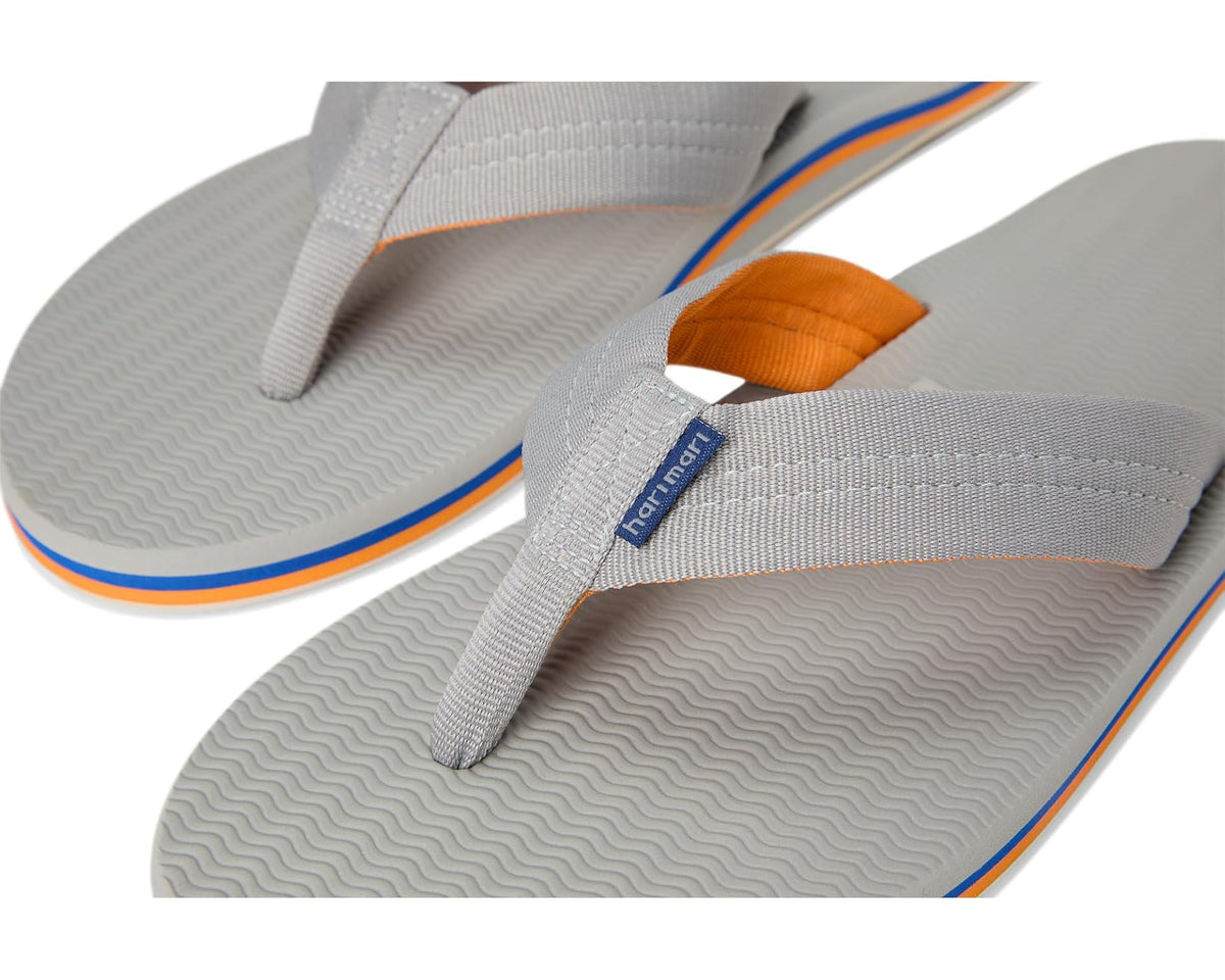 Men's hari mari flip-flops close-up of light gray strap with orange lining and logo