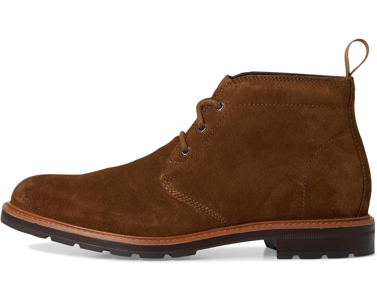 Brown nubuck chukka boots with lace-up closure, stitched panels, and low-profile sole