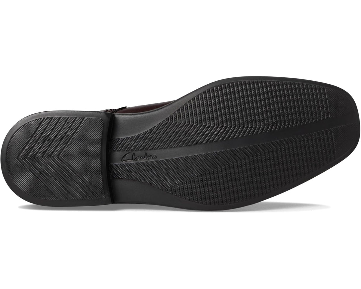 Black rubber outsole with textured tread pattern on lace-up dress shoe