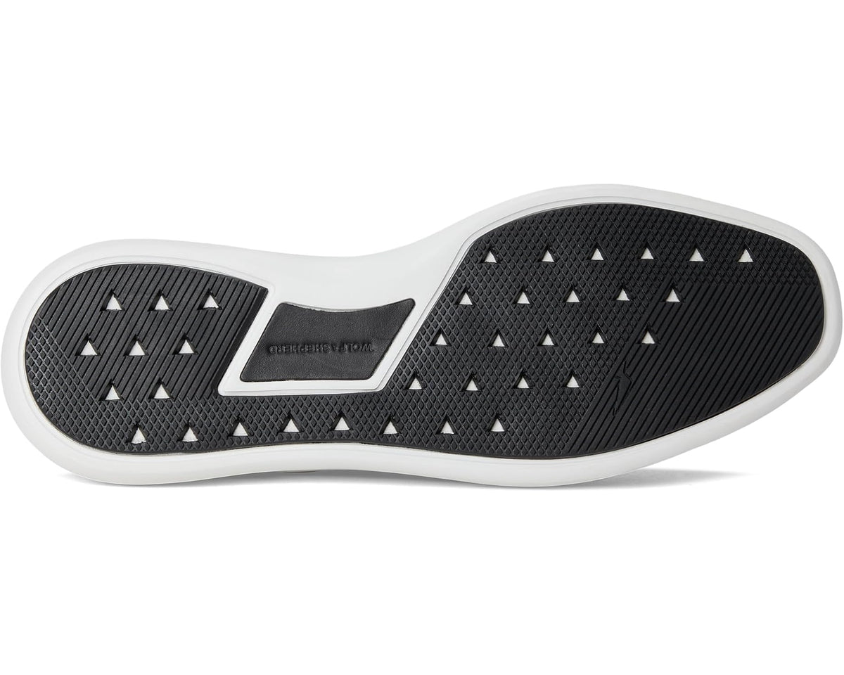 Black rubber outsole tread with contrast white edge on derby sneaker