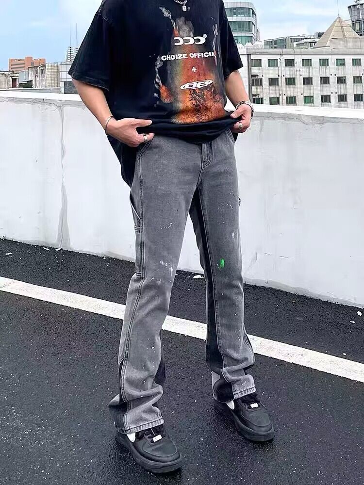 Gray washed denim jeans with subtle splatter, straight leg and stacked cuff