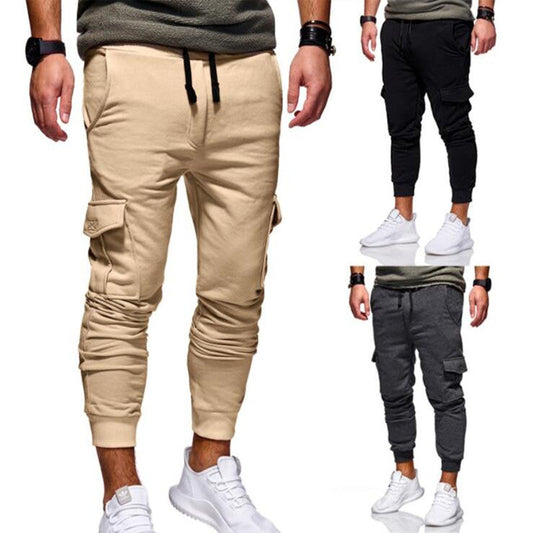 Men’s cargo sweatpants in tan/beige, drawstring waistband, cuffed jogger legs, side pockets.