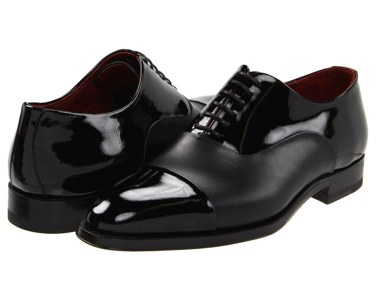 Black patent leather lace-up oxford dress shoes with cap toe and black laces