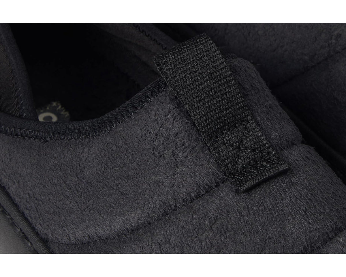 Close-up of black suede upper and adjustable strap on Crocs clog