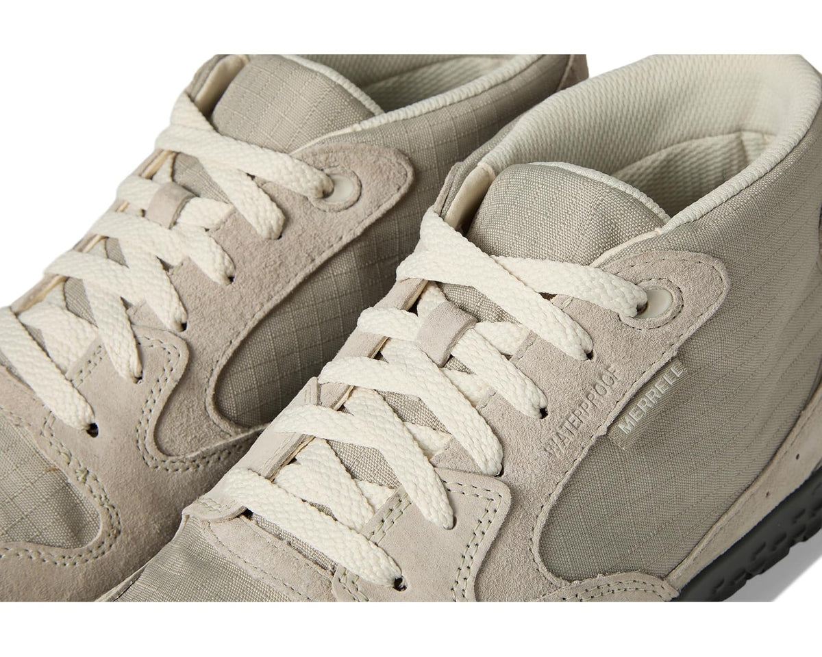 Men's light beige sneakers close-up of laces and side panel with MERRELL logo.