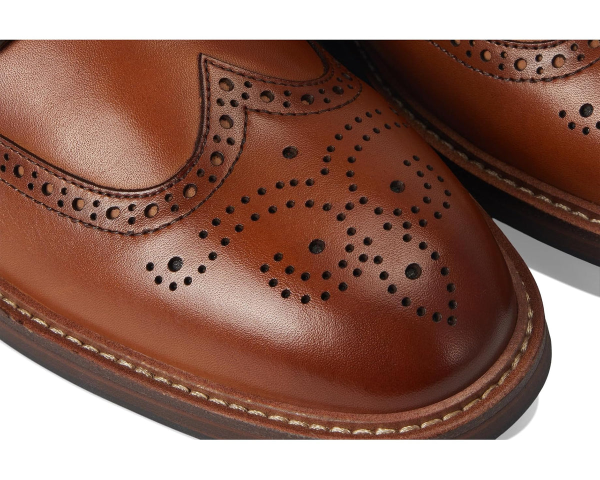 Saddle tan leather wingtip oxford toe with perforated brogue detail and stitch trim