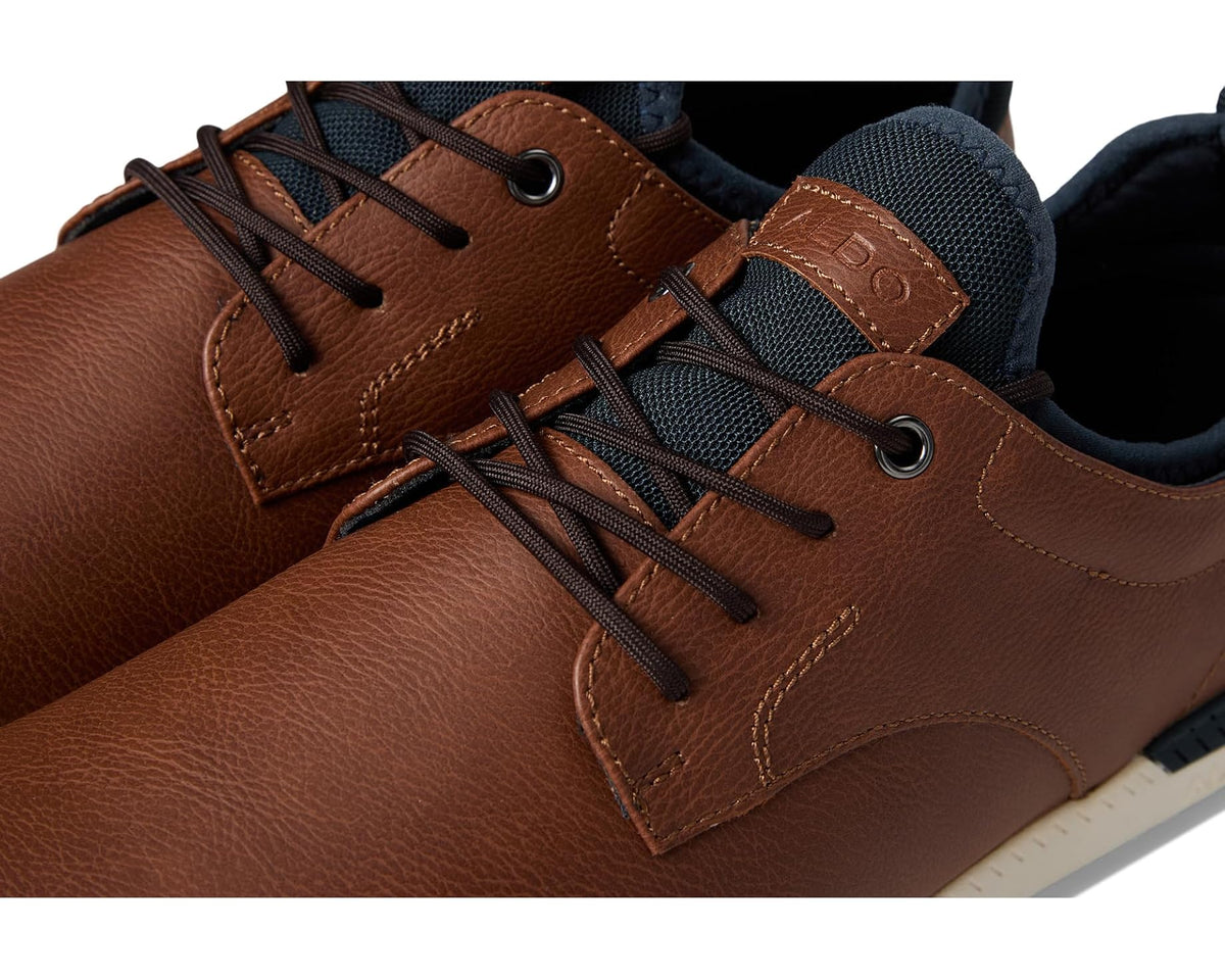Cognac leather sneaker close-up: lace eyelets, stitched overlays, ALDO tab