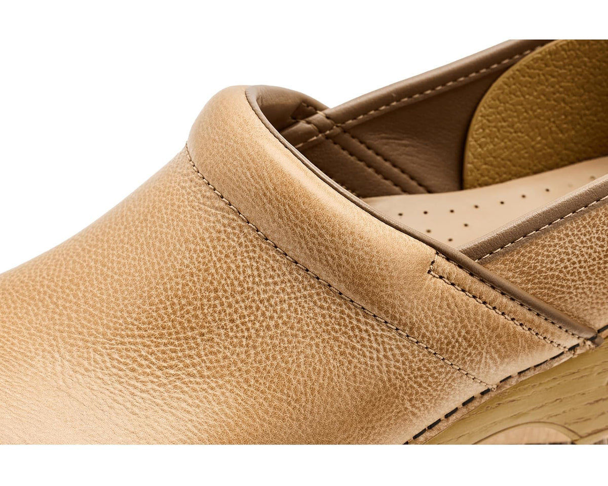Close-up of honey leather slip-on clog upper with detailed stitching