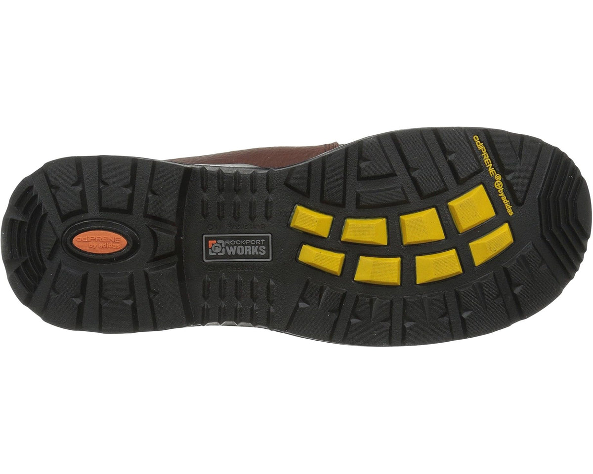 Brown work boot outsole with black tread and yellow traction pads
