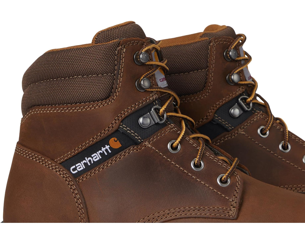 Brown leather lace-up work boot close-up with metal eyelets and Carhartt logo patch