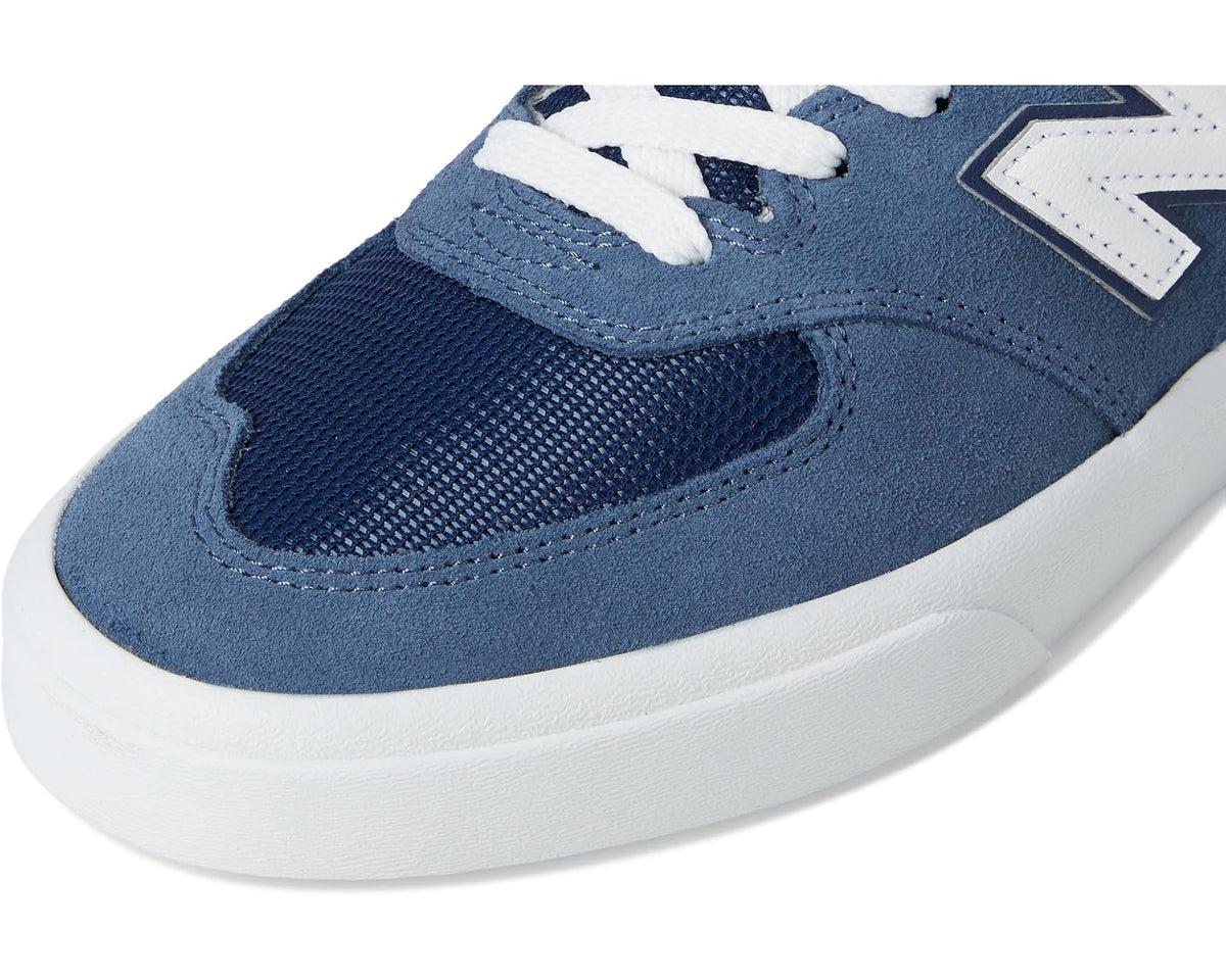 Indigo blue suede and mesh sneakers with white laces and bold N logo