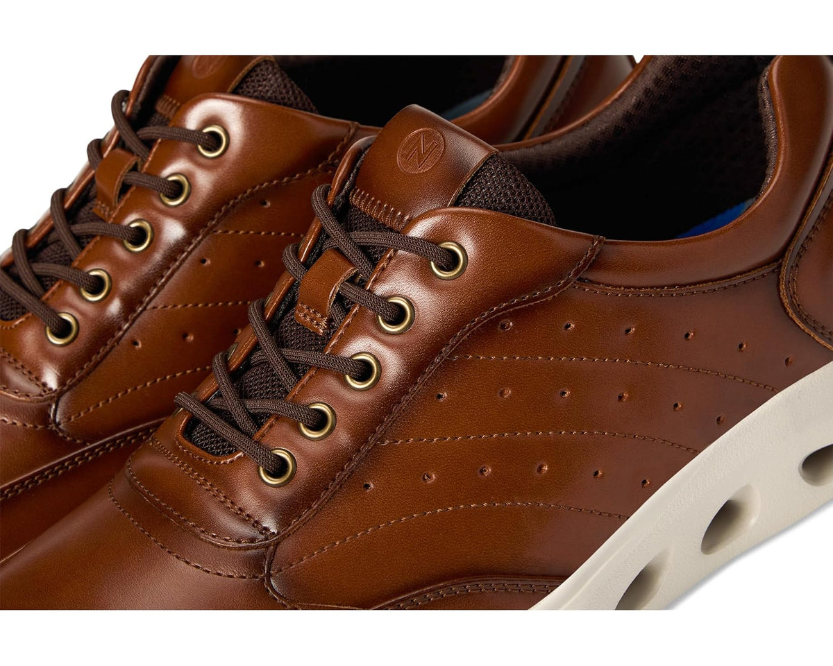Men's Nunn Bush cognac lace-up sneakers close-up, metal eyelets and seam stitching