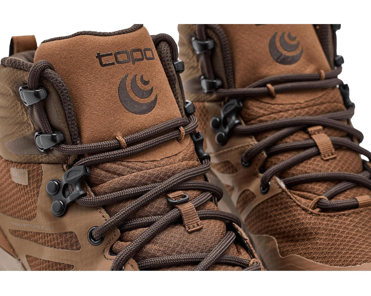 Brown upper with mesh, lace system, buckle straps, and logo patch