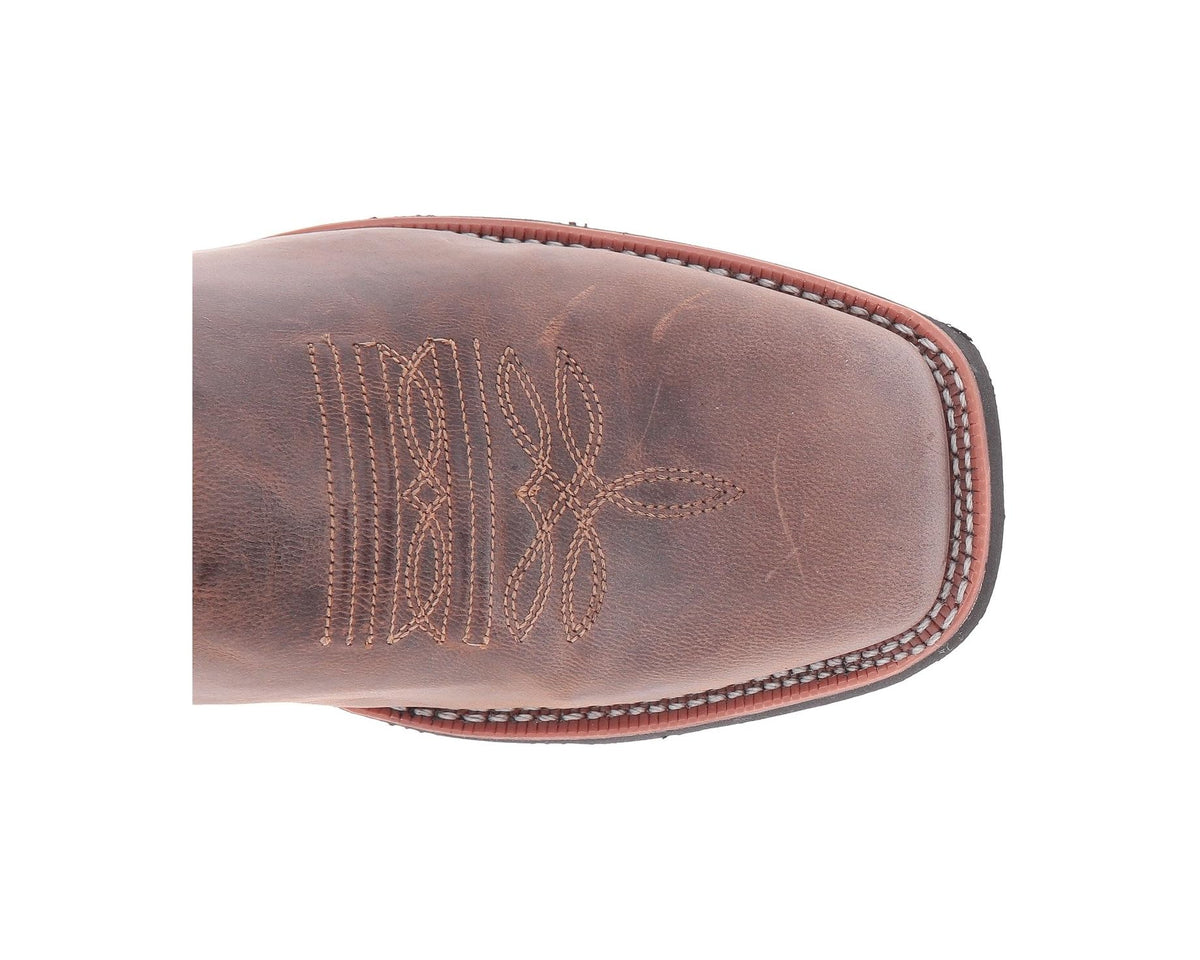 Western boot toe with tan stitch detailing and contrasting dark paneling