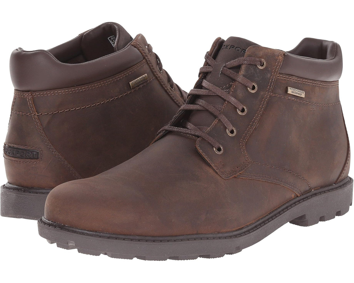 Tan lace-up plain-toe chukka-style boots with padded collar and dark rubber sole