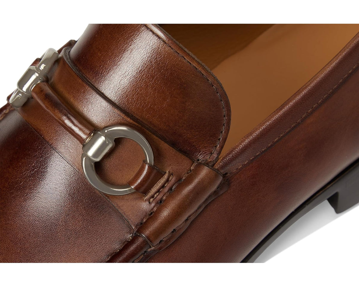 Close-up of tabaco leather loafer strap with metal bit hardware and stitching