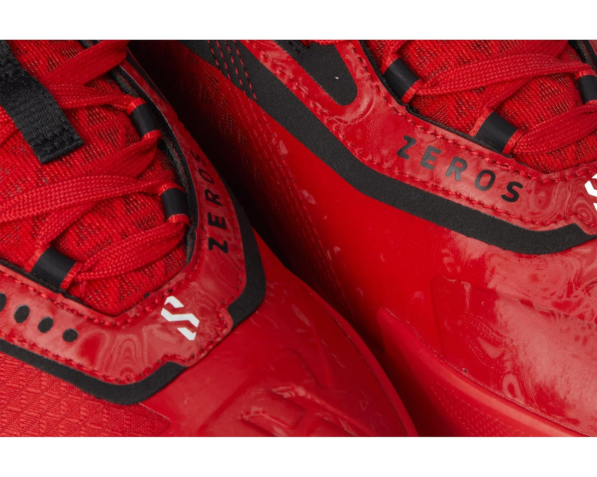 Men's PUMA basketball shoes close-up, red panels with black trim and lace detail.