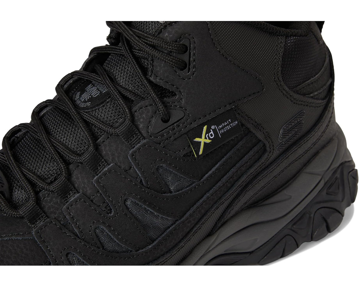 Men's black lace-up work boot close-up of laces, tongue patch, and side panels