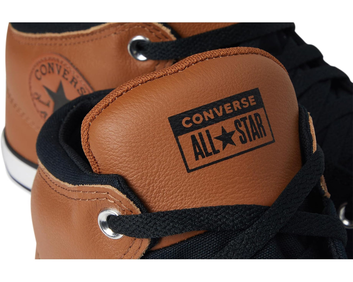 Converse All Star logo patch on tan leather high-top sneaker with black laces