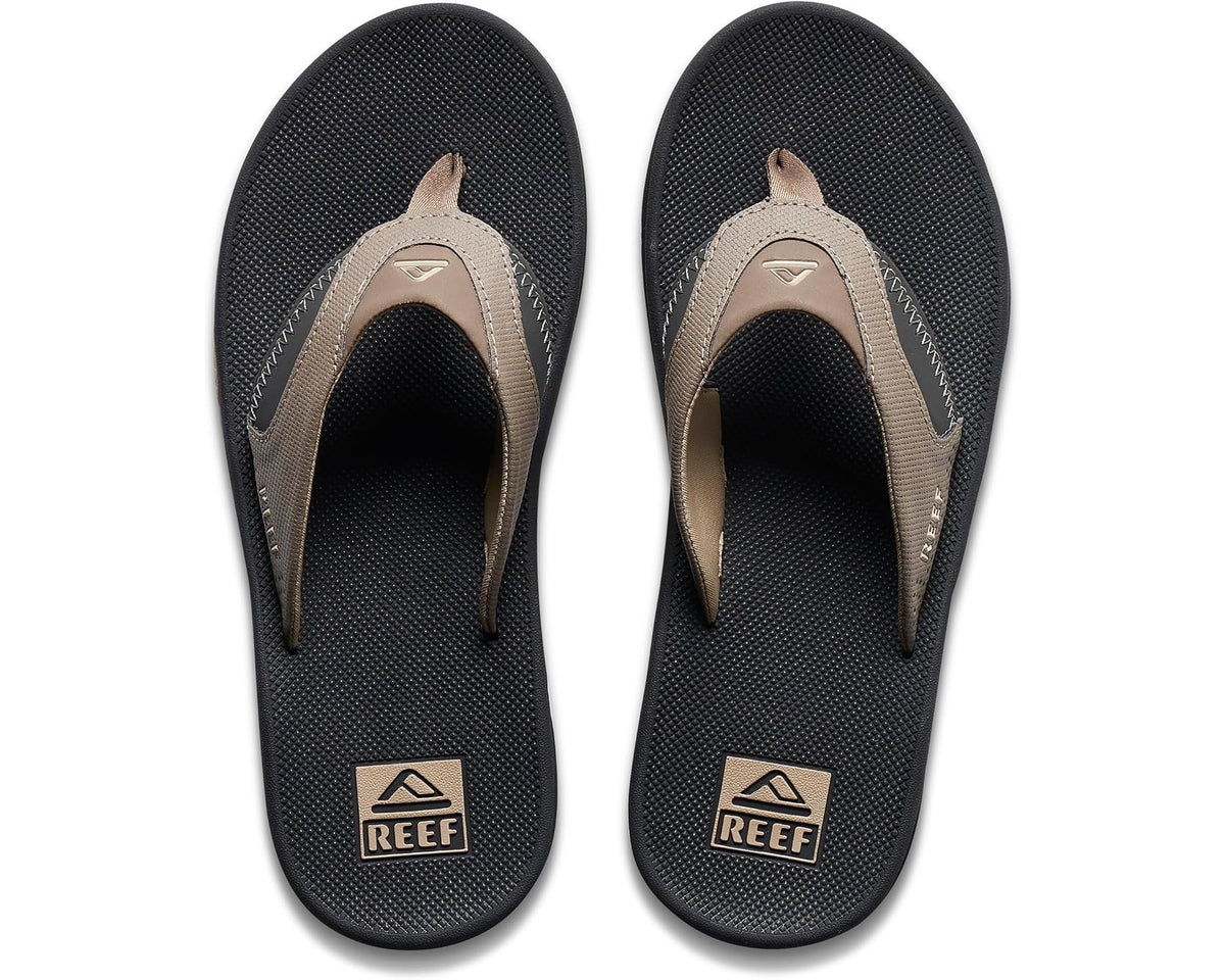 Pair of tan and black flip-flop sandals with logo footbeds