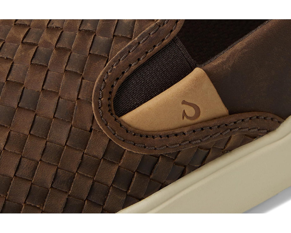 Close-up of dark brown woven upper with elastic gore and tan logo patch