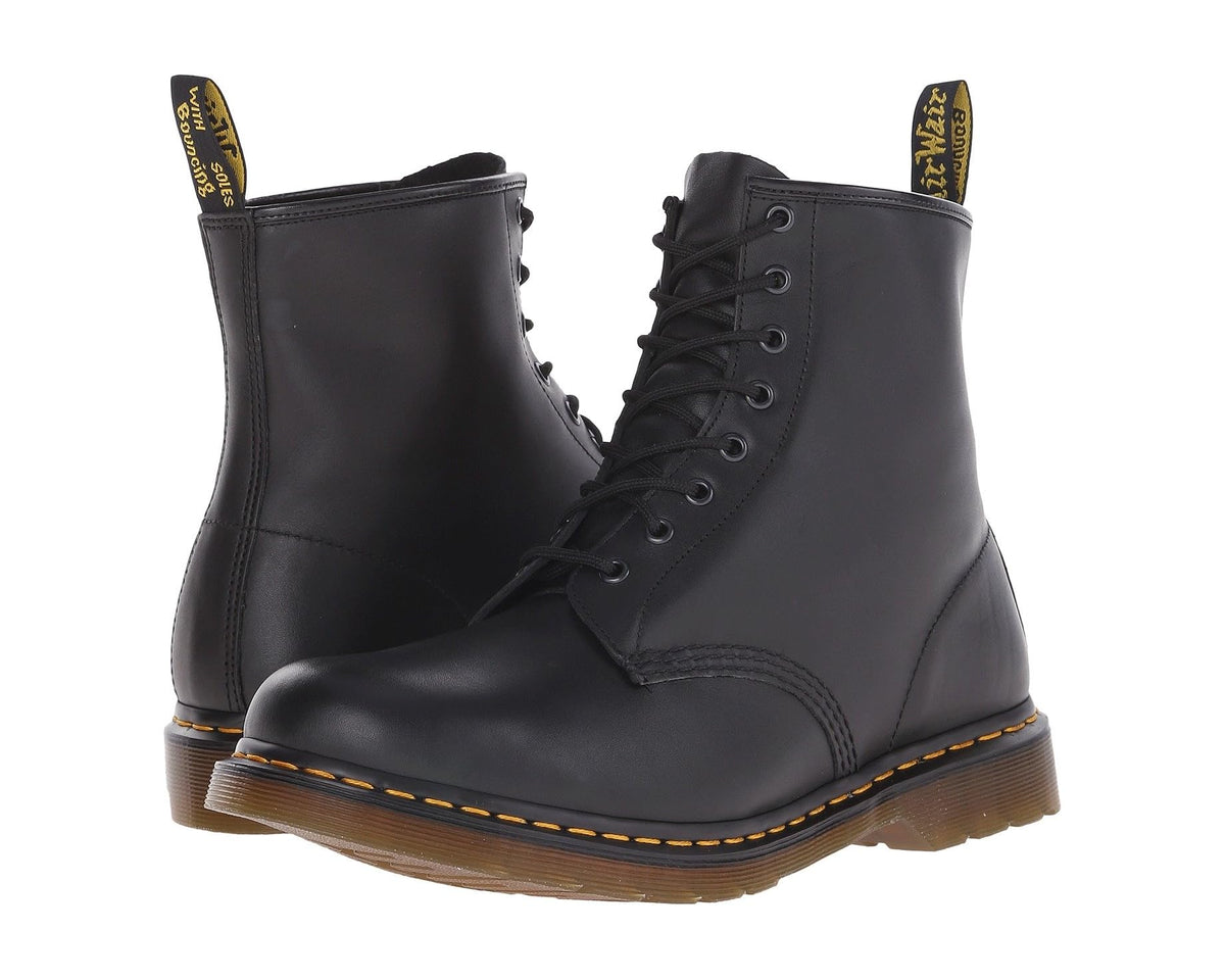 Black leather lace-up ankle boots with yellow stitching and chunky brown sole