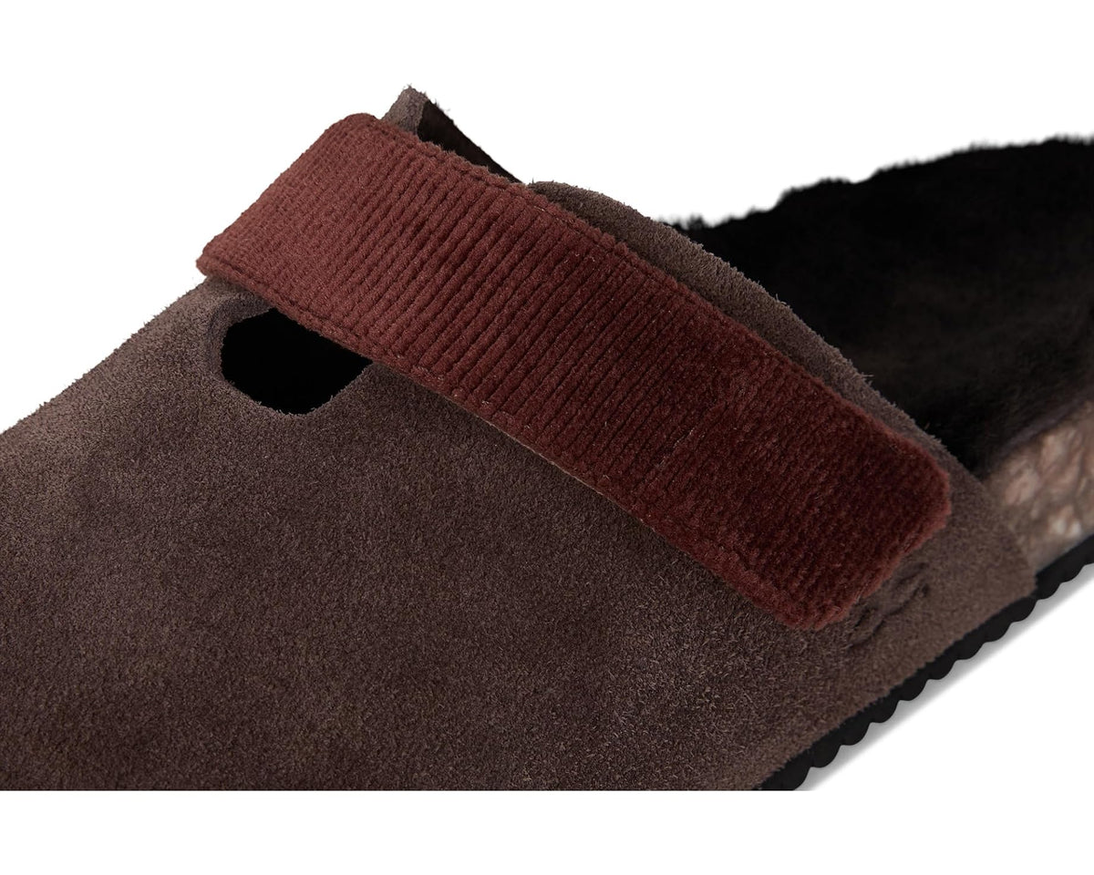 Close-up of dark espresso upper and brown corduroy-like strap over fuzzy lining