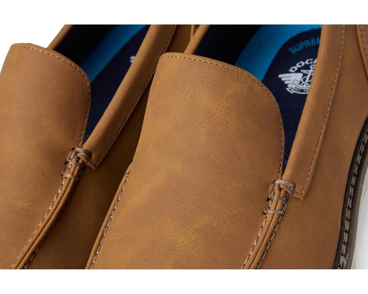 Close-up of tan loafer upper with stitching and decorative laces