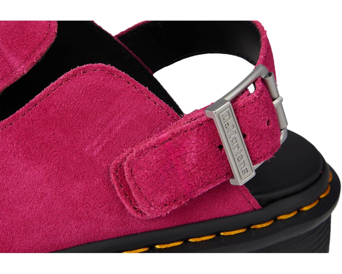 Close-up of fuchsia suede and side buckle strap with rectangular metal branding