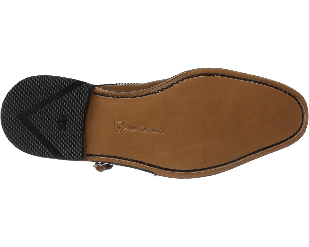 Men's leather monk strap shoe with dark outsole and brand-marked insole
