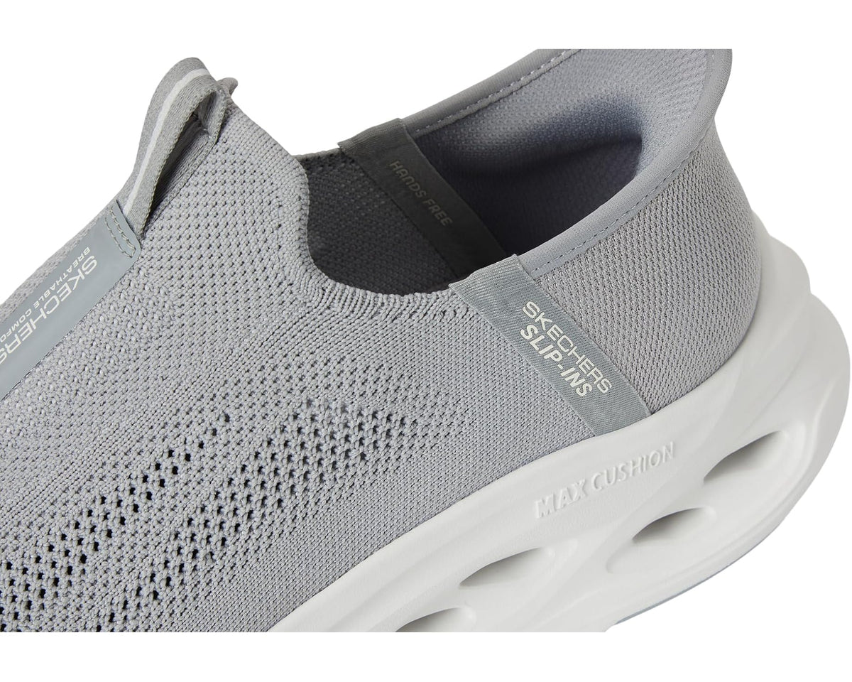 Men's SKECHERS slip-on sneaker close-up, grey knit upper with 'SKECHERS Slip-ins' label