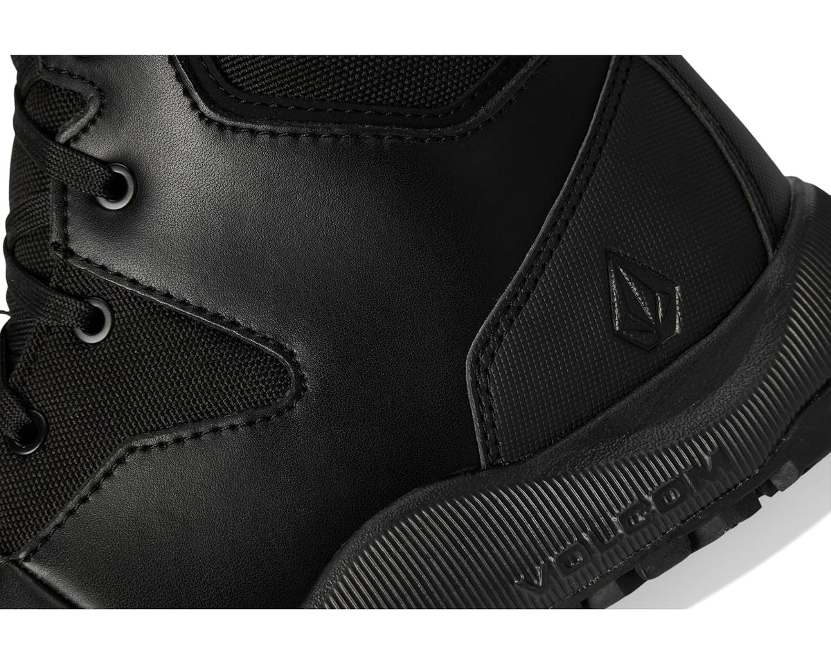 Black waterproof boot upper with stitched panels and ribbed rubber outsole tread