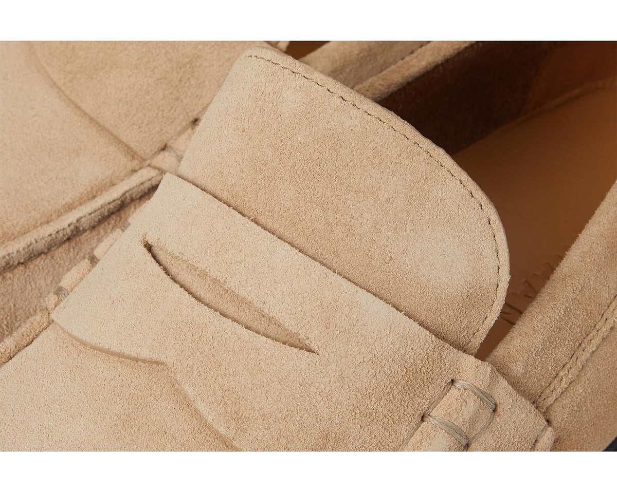 Close-up of suede penny loafer upper with strap detail and visible stitching