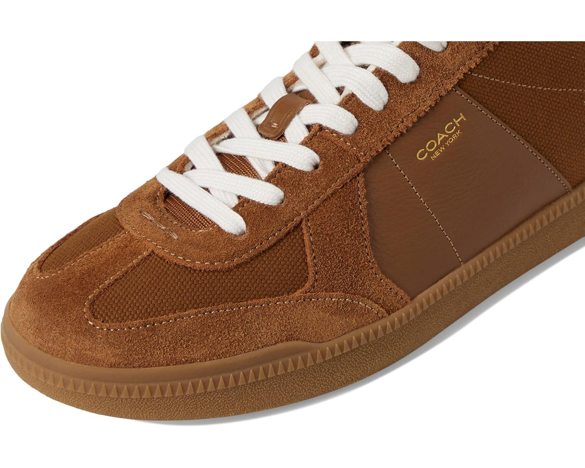 COACH sneakers close-up of white laces, brown suede toe and side panels