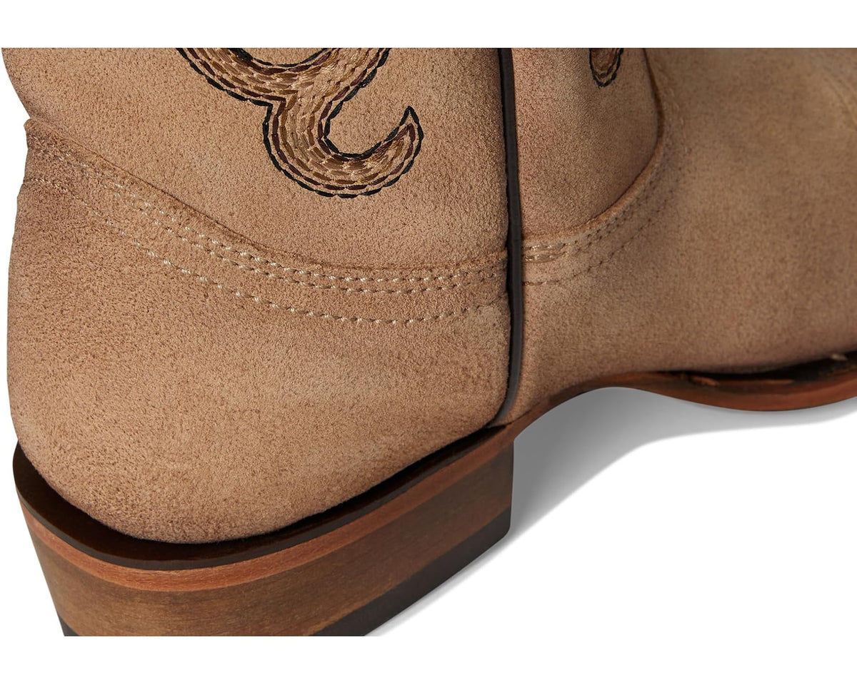 Sand suede boot ankle and heel close-up with contrast stitching and wooden-style heel