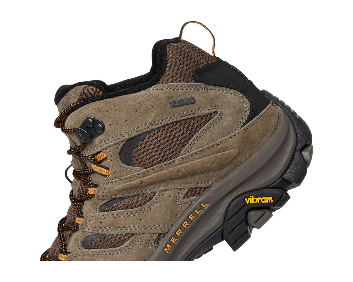 Men's mid-top hiking boot close-up showing Merrell logo, lace loops, and tread