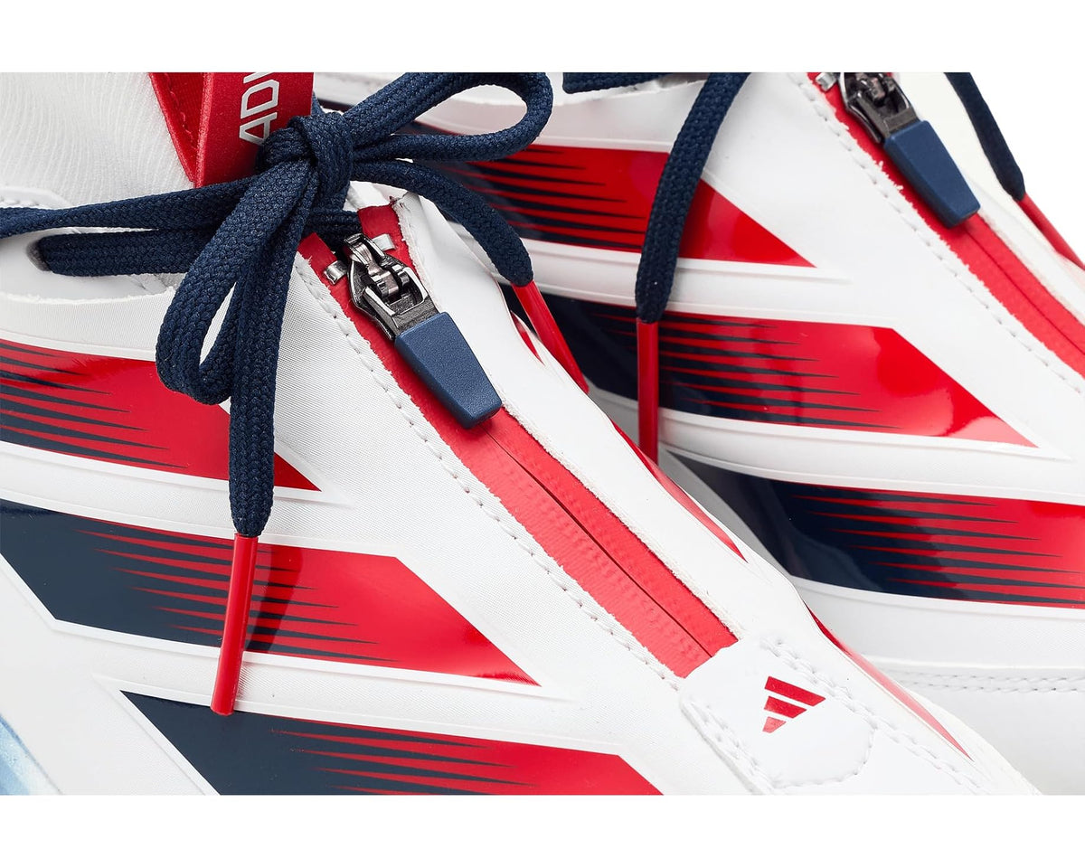 Close-up of adidas baseball cleat upper with lace eyelets, white panels and red/navy graphics