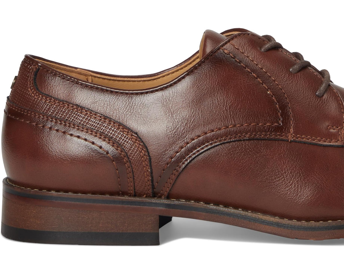 Men's medium brown leather lace-up oxford shoes, close-up of quarter panel stitching