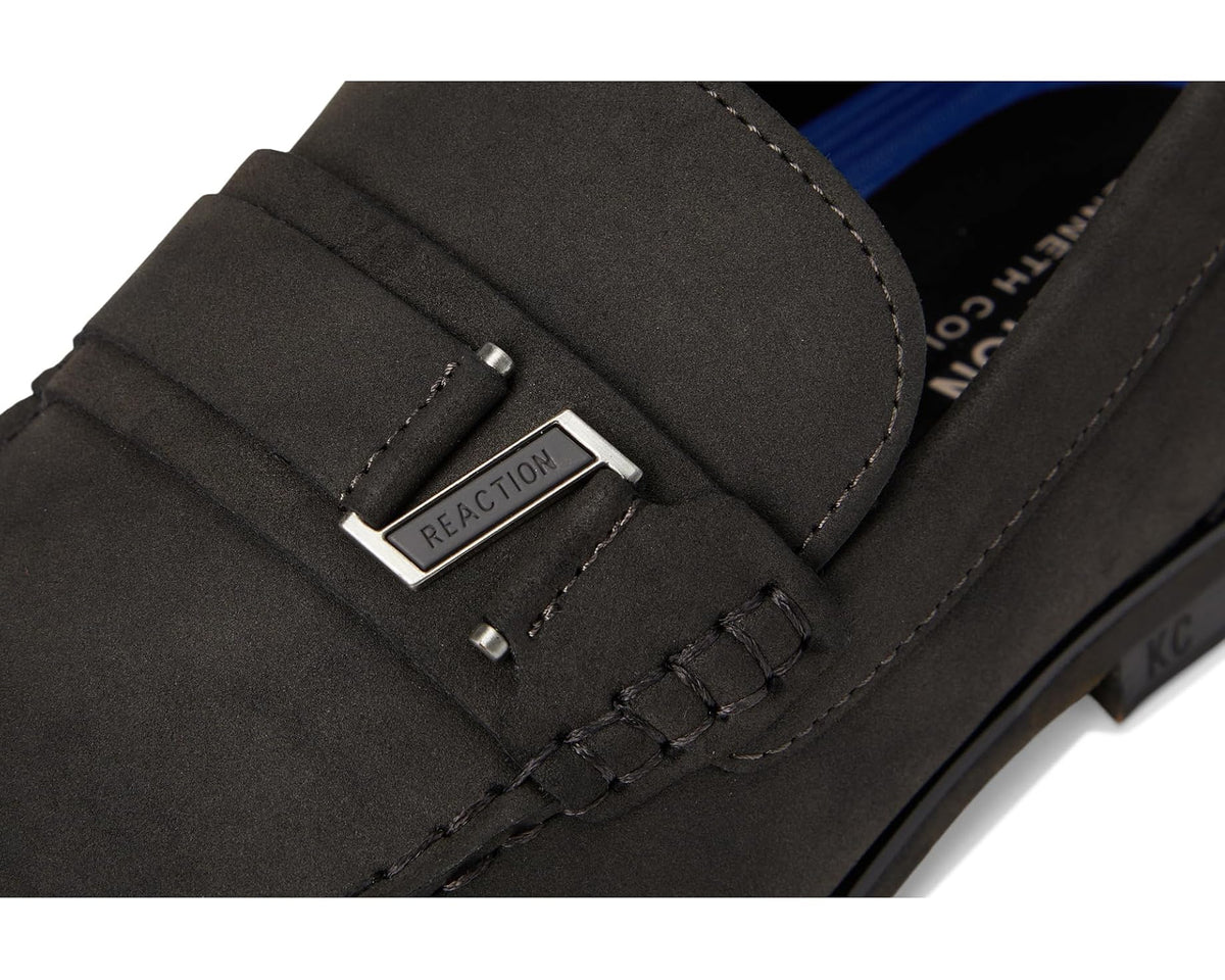 Close-up of dark grey suede loafer with silver buckle and bar hardware